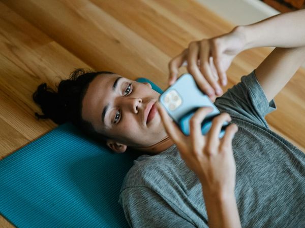 Comfortable home setting with a yoga mat rolled out on the floor.
